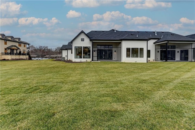 rear view of property with a lawn