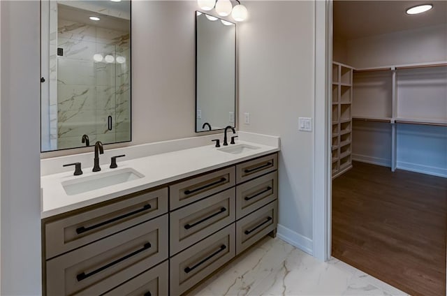 bathroom featuring vanity, a shower with shower door, and wood-type flooring