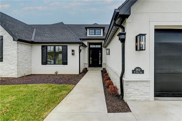 entrance to property with a lawn