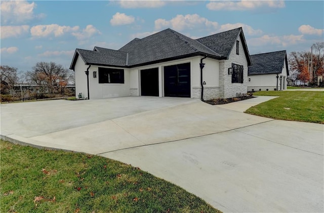 view of front facade with a front yard and a garage