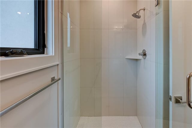 bathroom with a shower with door