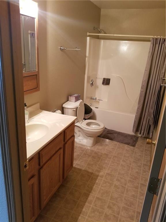 full bathroom with tile patterned flooring, shower / bath combo, toilet, and vanity