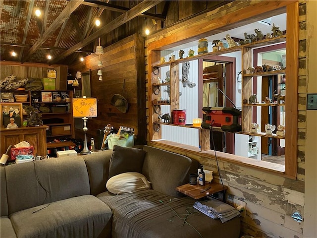 interior space featuring beamed ceiling and wooden walls