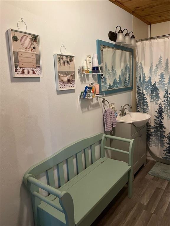 bathroom with curtained shower, hardwood / wood-style floors, vanity, and wooden ceiling