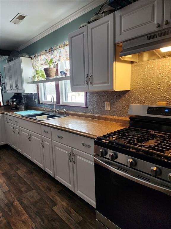 kitchen featuring crown molding, white cabinetry, sink, and gas range