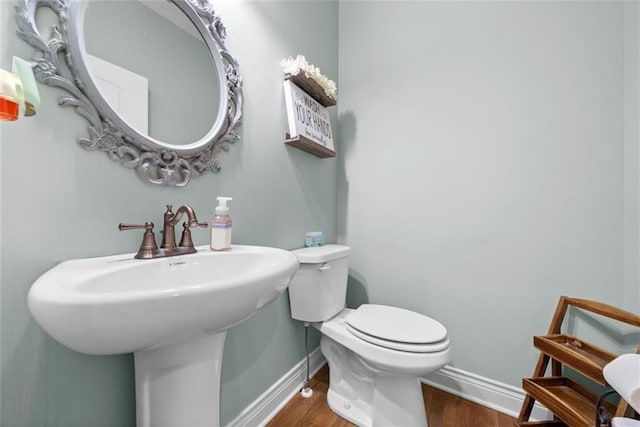 bathroom featuring sink, hardwood / wood-style floors, and toilet