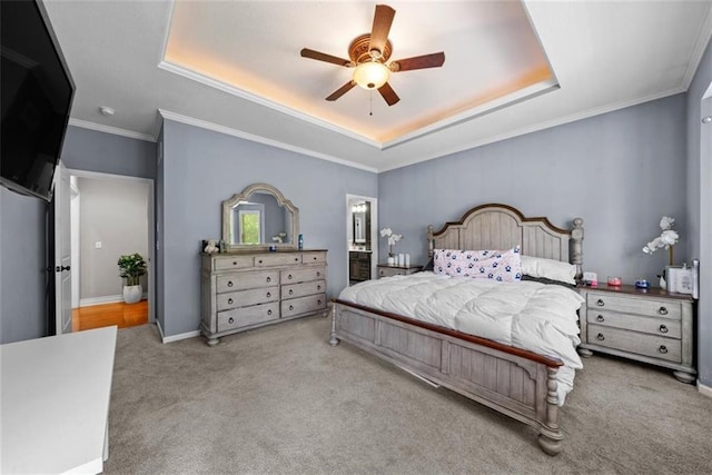 bedroom with a raised ceiling, crown molding, light carpet, and ceiling fan