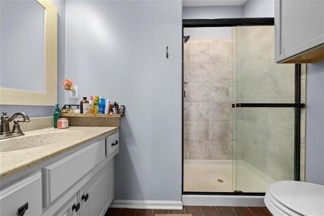 bathroom with vanity, toilet, and walk in shower