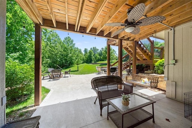 view of patio / terrace with an outdoor living space with a fire pit and ceiling fan