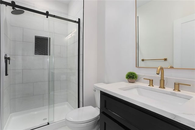 bathroom with vanity, toilet, and walk in shower