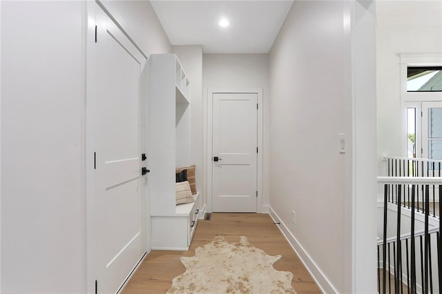 hallway with light hardwood / wood-style flooring