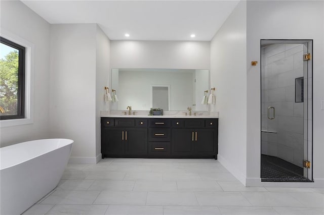 bathroom featuring shower with separate bathtub and vanity