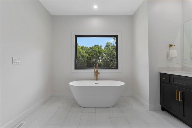 bathroom featuring vanity and a tub to relax in