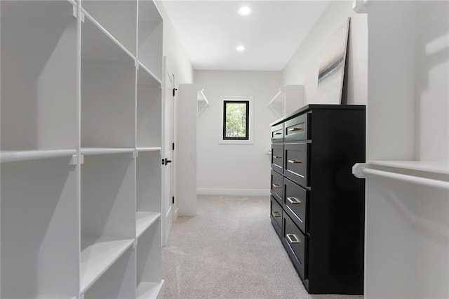 spacious closet featuring light carpet