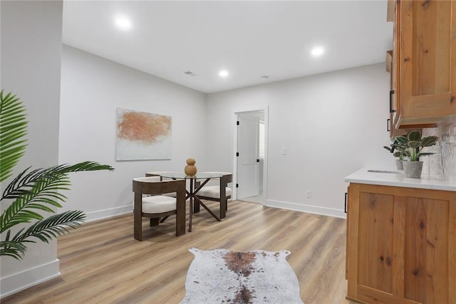 dining space with light hardwood / wood-style flooring