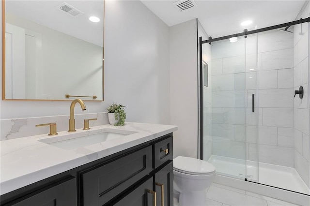 bathroom with an enclosed shower, vanity, and toilet