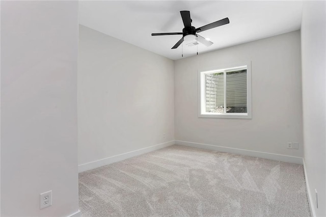 empty room with light colored carpet and ceiling fan