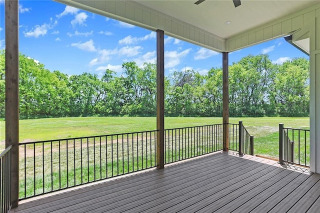 deck featuring ceiling fan and a yard