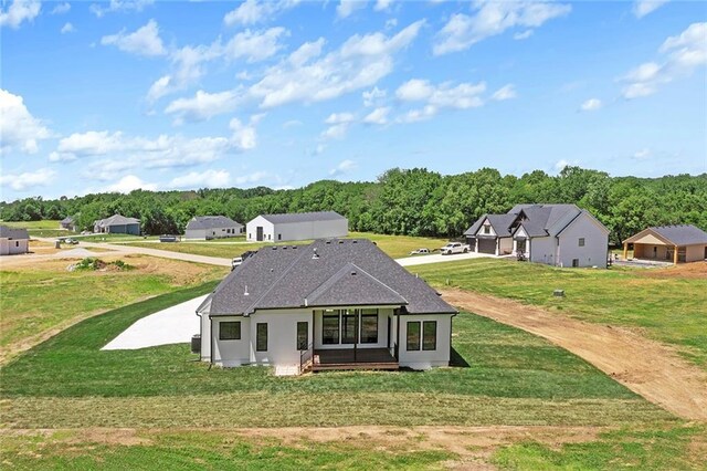 rear view of property featuring a yard