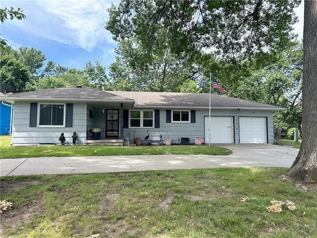 ranch-style house featuring a garage and a front lawn