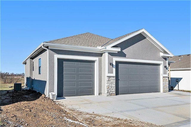 exterior space with a garage and central air condition unit