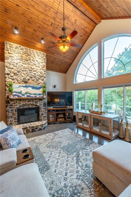 living room featuring wood-type flooring, a fireplace, ceiling fan, and a wealth of natural light