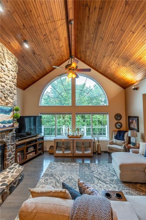 living room with a fireplace, hardwood / wood-style floors, ceiling fan, and high vaulted ceiling