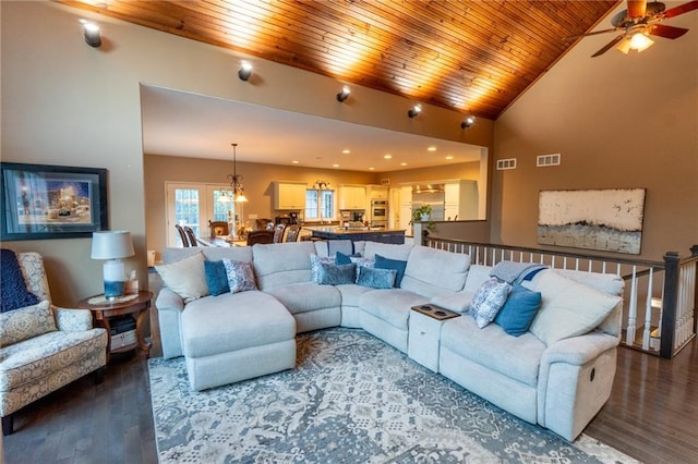 living room with wood-type flooring, ceiling fan with notable chandelier, wood ceiling, and high vaulted ceiling