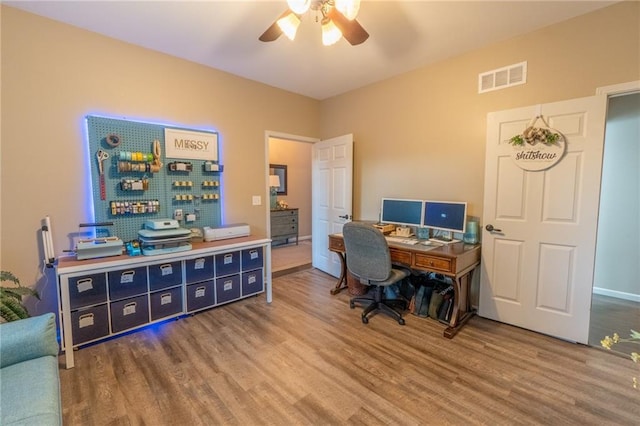 home office with ceiling fan and hardwood / wood-style floors