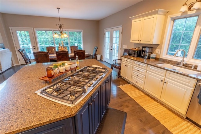 kitchen featuring white cabinets, sink, dark hardwood / wood-style flooring, and a healthy amount of sunlight