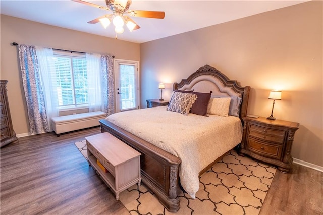 bedroom with ceiling fan, access to exterior, and hardwood / wood-style floors