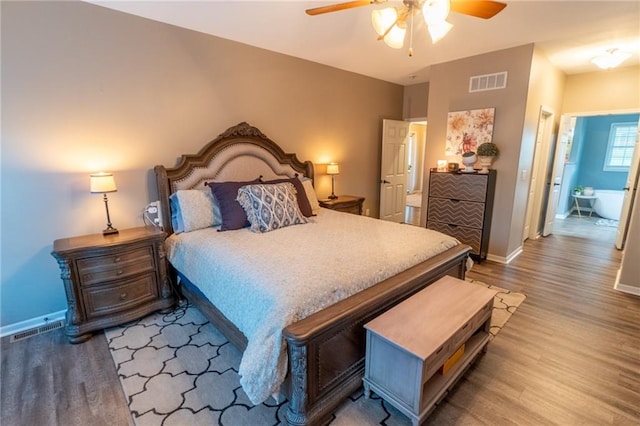 bedroom with connected bathroom, ceiling fan, and hardwood / wood-style flooring