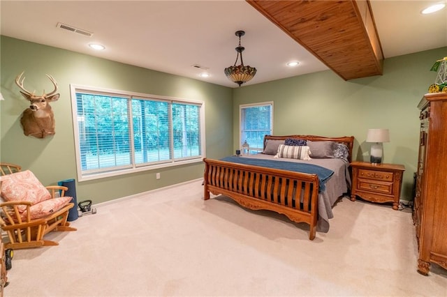 carpeted bedroom with multiple windows