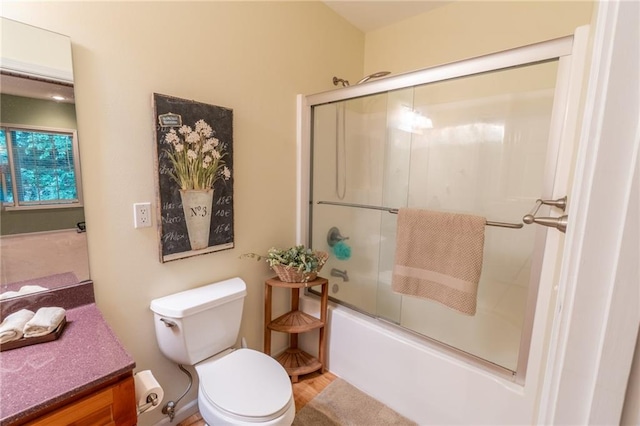 full bathroom with enclosed tub / shower combo, vanity, toilet, and hardwood / wood-style flooring