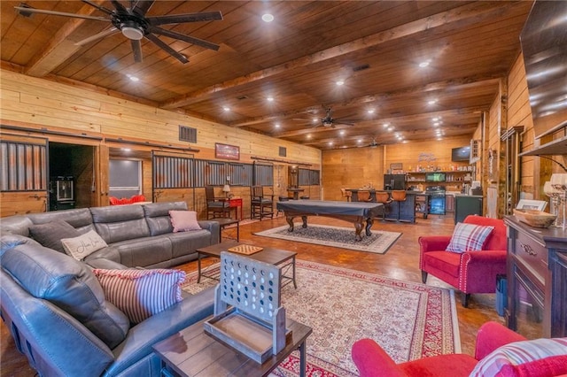 living room featuring ceiling fan, wood ceiling, beam ceiling, wooden walls, and pool table