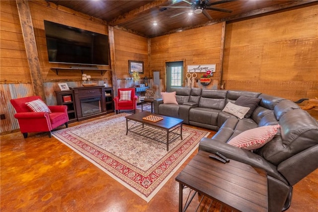 living room featuring wooden walls, ceiling fan, wooden ceiling, and a fireplace