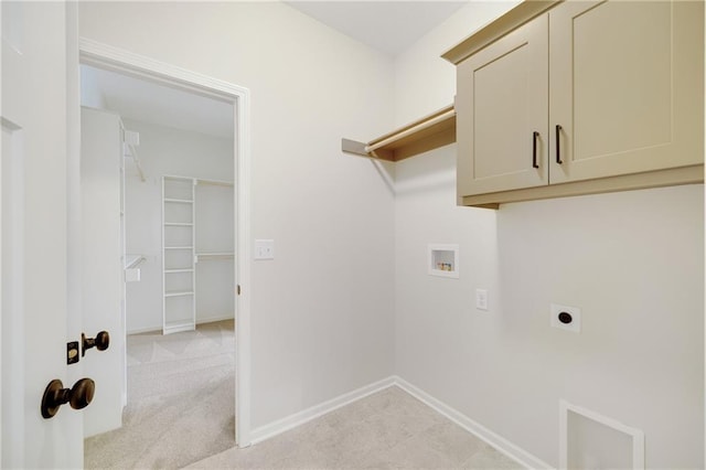 laundry area with electric dryer hookup, light colored carpet, cabinets, and washer hookup