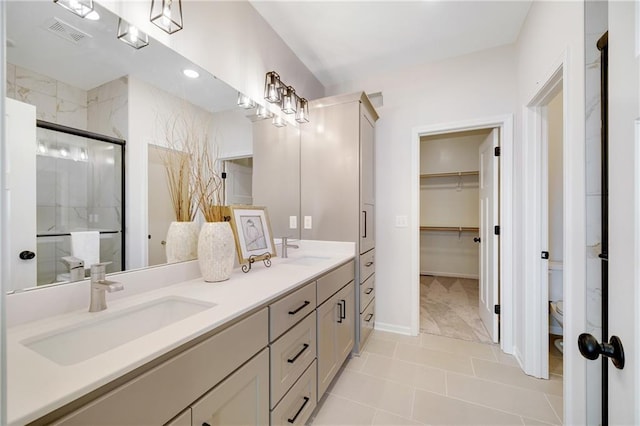 bathroom with tile patterned flooring, vanity, and walk in shower