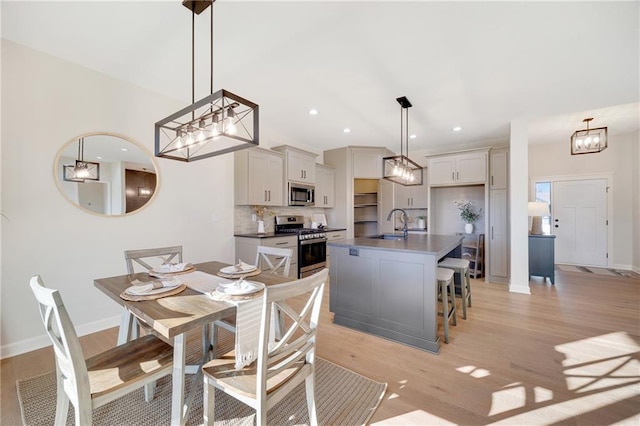 dining space featuring light hardwood / wood-style floors and sink