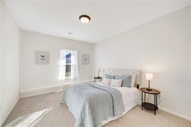 bedroom featuring light carpet