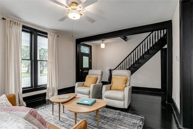 living room featuring hardwood / wood-style floors and ceiling fan