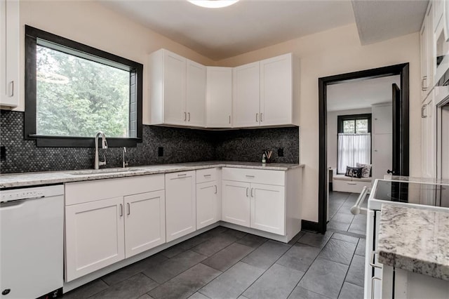 kitchen featuring white dishwasher, a healthy amount of sunlight, white cabinetry, and sink