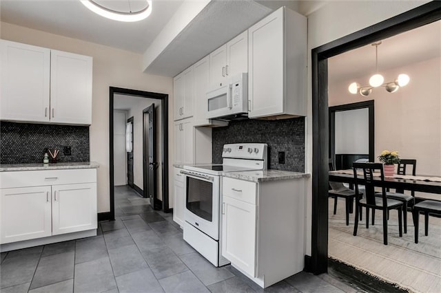 kitchen featuring white appliances, decorative backsplash, decorative light fixtures, light stone counters, and white cabinetry