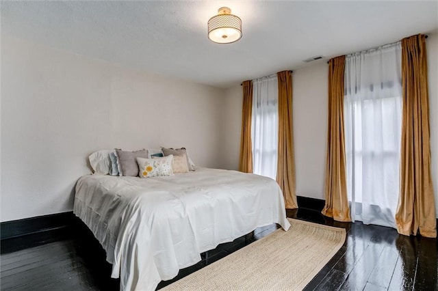 bedroom featuring dark wood-type flooring