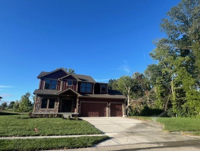 view of front of property featuring a front lawn and a garage