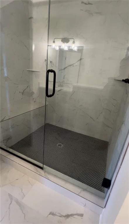 bathroom with a shower with door