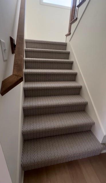 stairs featuring hardwood / wood-style floors