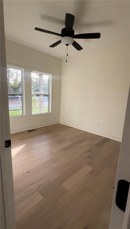 empty room featuring hardwood / wood-style flooring and ceiling fan