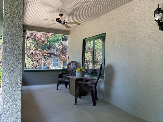 exterior space featuring plenty of natural light, ceiling fan, and concrete flooring