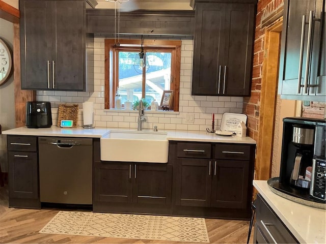 kitchen featuring light hardwood / wood-style floors, dark brown cabinetry, and stainless steel dishwasher